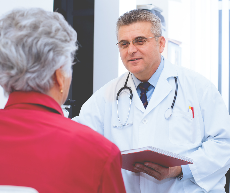 older male doctor talking to older woman in a medical setting