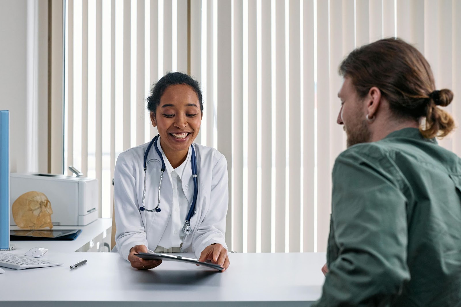 phlebotomist in light conversation with a patient 